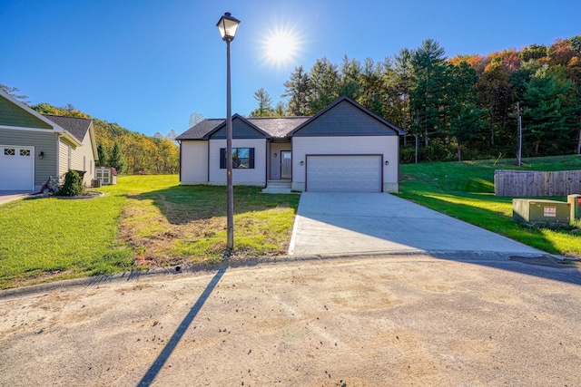 view of front of property with a front yard and a garage