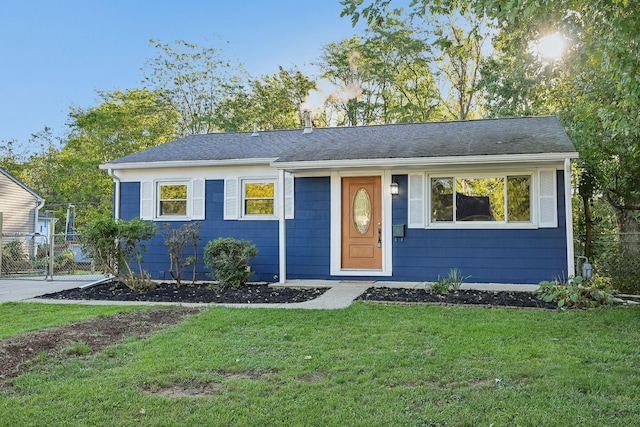 ranch-style home with a front lawn