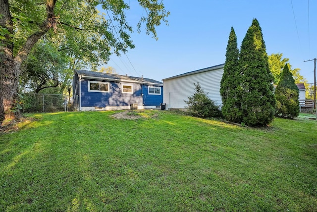 rear view of house with a yard