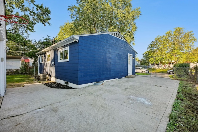 view of side of property featuring a patio and central AC unit