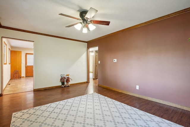 spare room with light wood-type flooring, ceiling fan, and crown molding