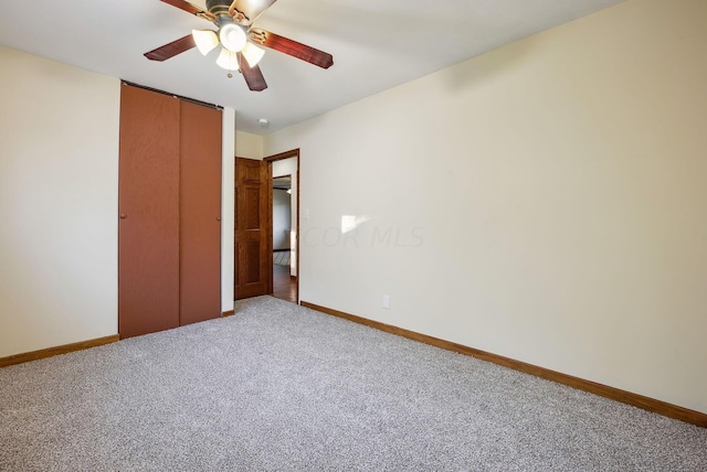 unfurnished bedroom with ceiling fan, carpet floors, and a closet