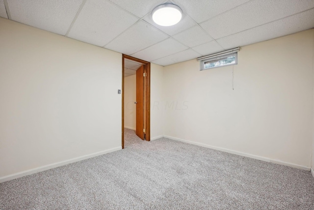 basement featuring carpet flooring and a drop ceiling