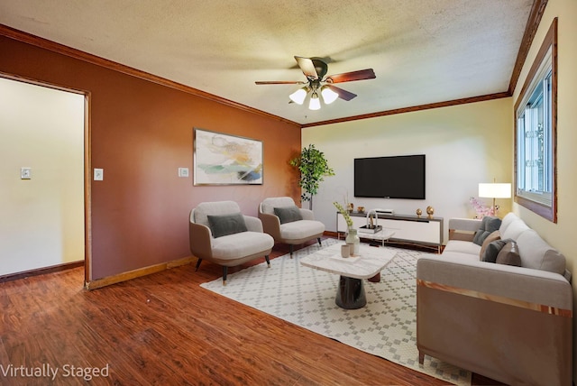 living room featuring ceiling fan, crown molding, wood-type flooring, and a textured ceiling