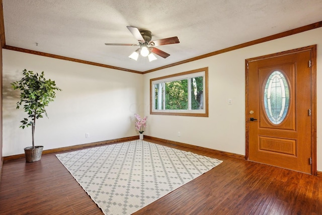 foyer entrance featuring a textured ceiling, crown molding, ceiling fan, and dark wood-type flooring