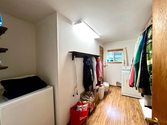 washroom featuring light wood-type flooring and independent washer and dryer