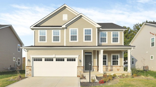 craftsman house featuring covered porch, a garage, and central AC