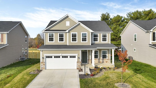 view of front of property with cooling unit, a garage, covered porch, and a front lawn