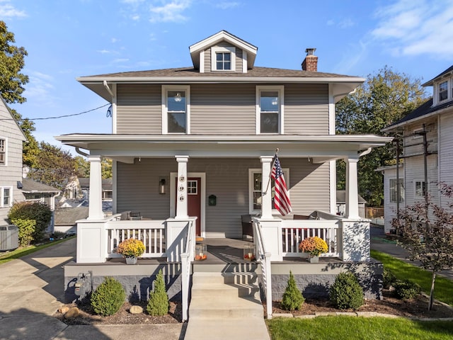 view of front facade featuring central AC and covered porch