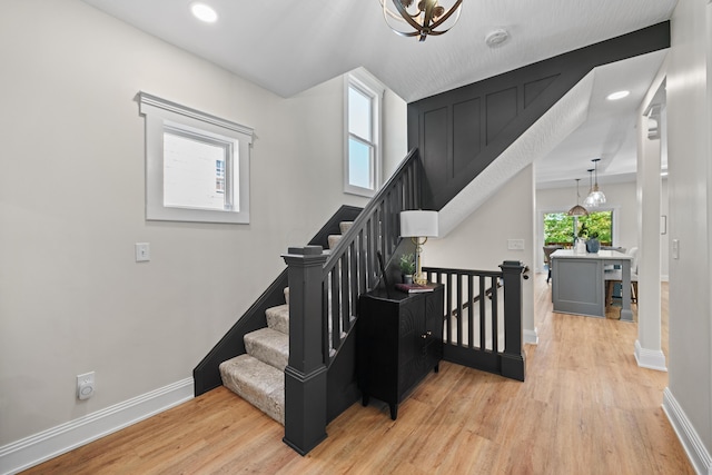 stairs with hardwood / wood-style floors