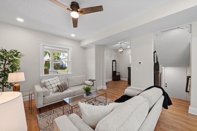 living room featuring light hardwood / wood-style flooring and ceiling fan