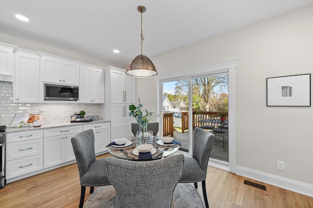 dining space with light hardwood / wood-style flooring