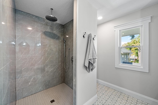 bathroom featuring tile patterned flooring and tiled shower