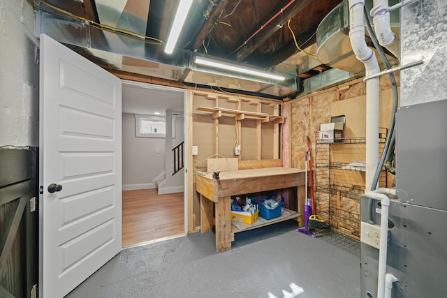 basement featuring a workshop area and hardwood / wood-style floors