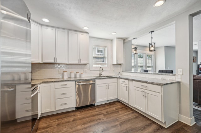 kitchen with white cabinetry, stainless steel dishwasher, dark wood-type flooring, and sink