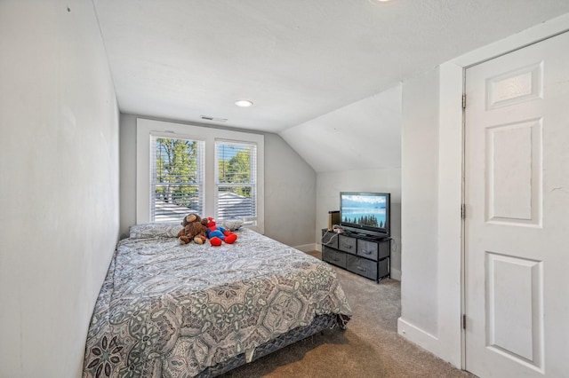 bedroom with light carpet and vaulted ceiling