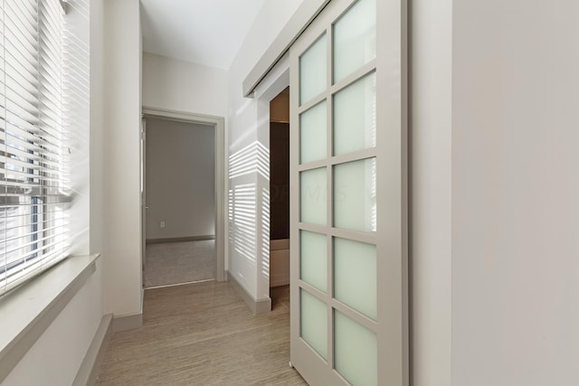 hallway with light hardwood / wood-style flooring