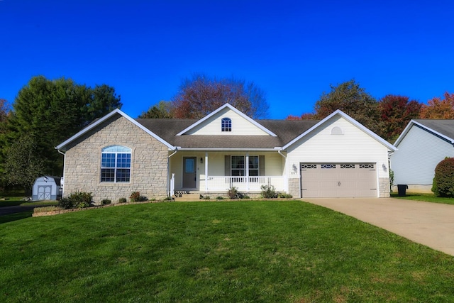 ranch-style home featuring covered porch, a garage, a storage shed, and a front yard