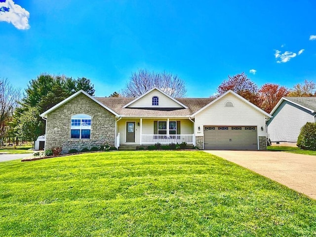 view of front of house featuring a garage, concrete driveway, stone siding, covered porch, and a front yard