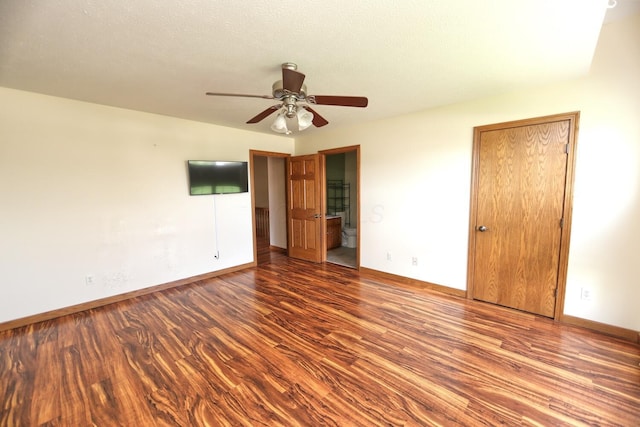 empty room featuring ceiling fan, baseboards, and wood finished floors