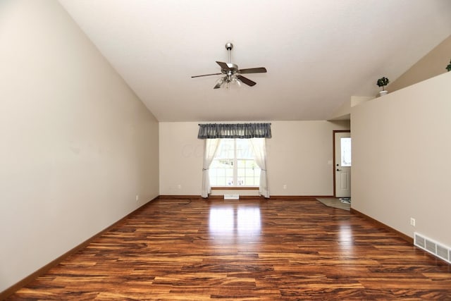 spare room with a ceiling fan, wood finished floors, baseboards, lofted ceiling, and visible vents