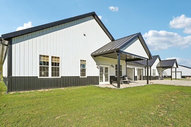 back of house with french doors, a patio, and a yard