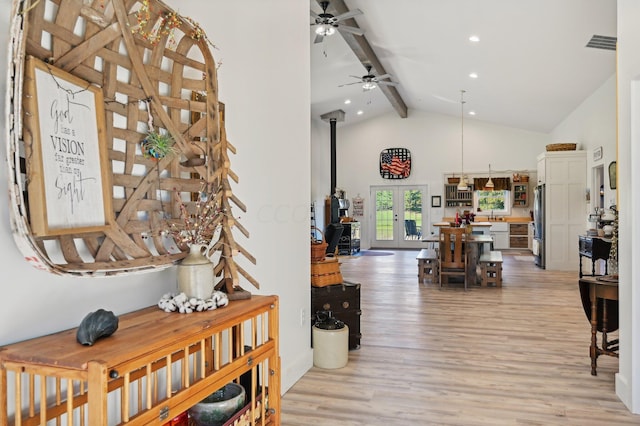 interior space with sink, light hardwood / wood-style flooring, beamed ceiling, and high vaulted ceiling