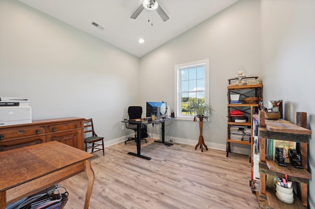 office area featuring light wood-type flooring, vaulted ceiling, and ceiling fan