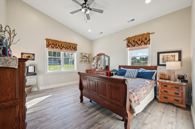 bedroom with ceiling fan, light hardwood / wood-style floors, and vaulted ceiling