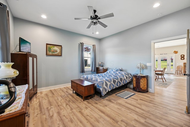 bedroom featuring ceiling fan, light hardwood / wood-style floors, and french doors