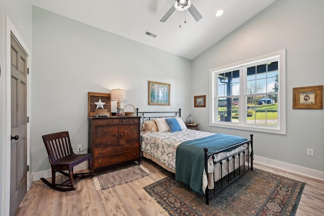 bedroom with ceiling fan, light wood-type flooring, and high vaulted ceiling