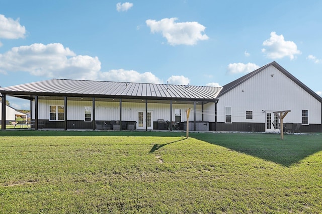 rear view of property featuring french doors and a yard