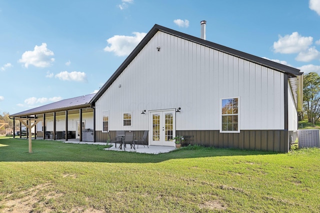 rear view of property featuring central AC, a yard, a patio, and french doors