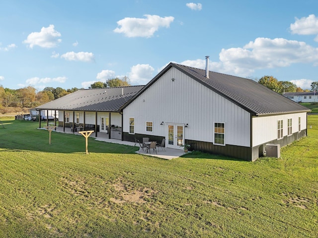 rear view of property with french doors, central AC unit, a patio area, and a lawn