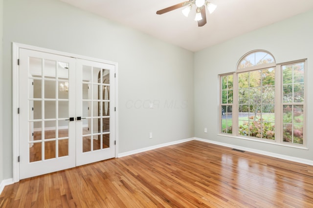 unfurnished room featuring french doors, ceiling fan, and hardwood / wood-style floors