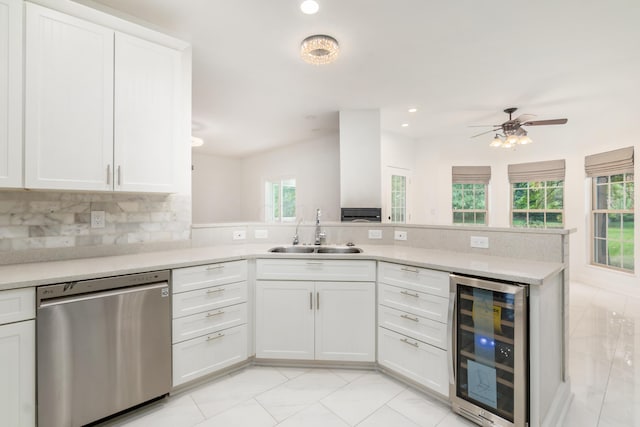 kitchen featuring white cabinets, wine cooler, stainless steel dishwasher, and sink