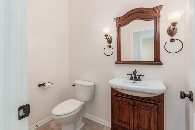 bathroom with tile patterned floors, vanity, and toilet