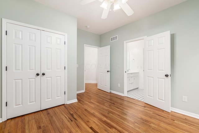 unfurnished bedroom featuring ceiling fan, light wood-type flooring, and a closet