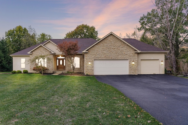 single story home with a lawn and a garage