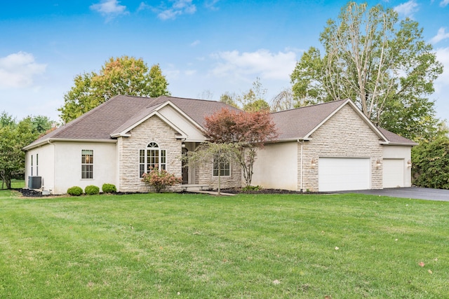 view of front of home with central AC, a front lawn, and a garage