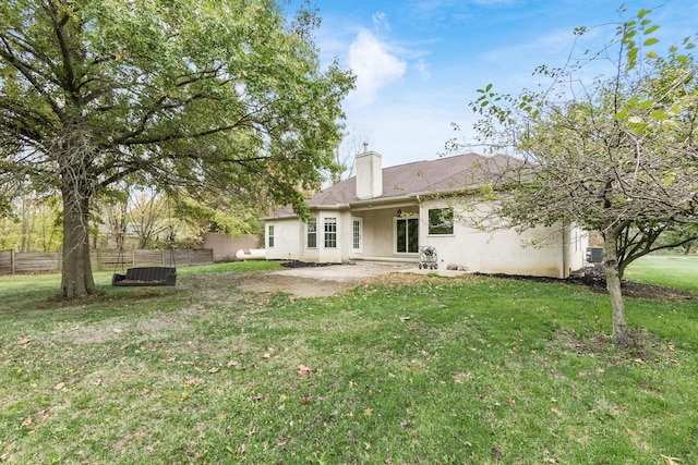 rear view of house with a yard