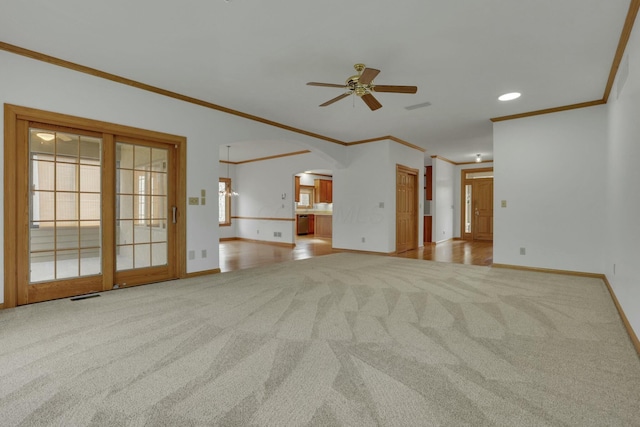 unfurnished living room featuring baseboards, visible vents, a ceiling fan, arched walkways, and carpet flooring