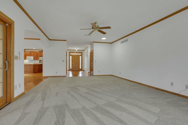 unfurnished living room featuring recessed lighting, light colored carpet, visible vents, baseboards, and crown molding