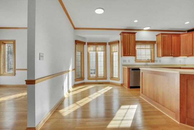 kitchen with light wood-style floors, light countertops, dishwasher, and crown molding