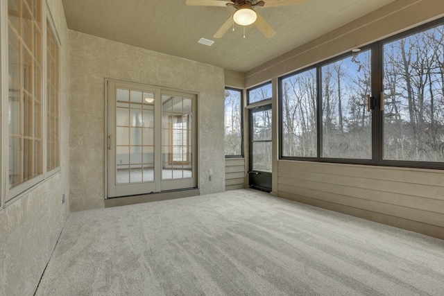 unfurnished sunroom with a ceiling fan