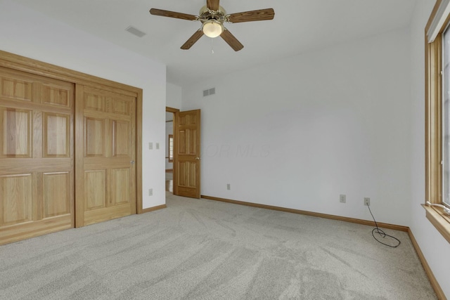 unfurnished bedroom featuring ceiling fan, carpet floors, visible vents, and baseboards