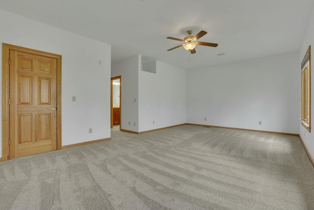 unfurnished room featuring light carpet, ceiling fan, and baseboards