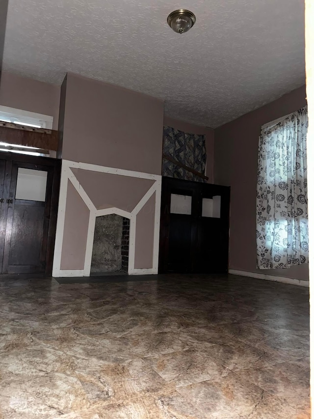 unfurnished living room featuring a textured ceiling