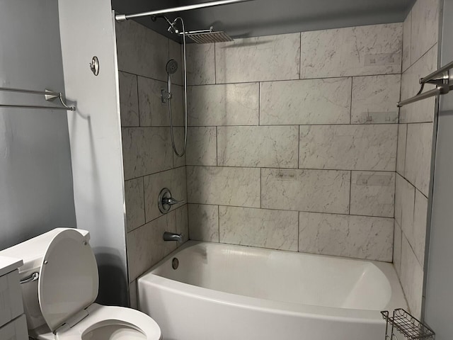 bathroom with tiled shower / bath combo and toilet