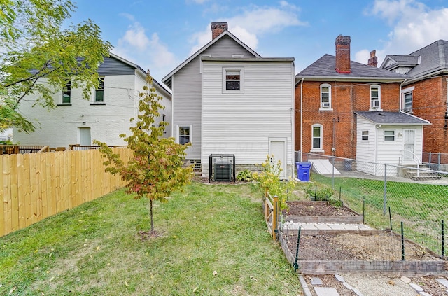 rear view of property featuring a lawn